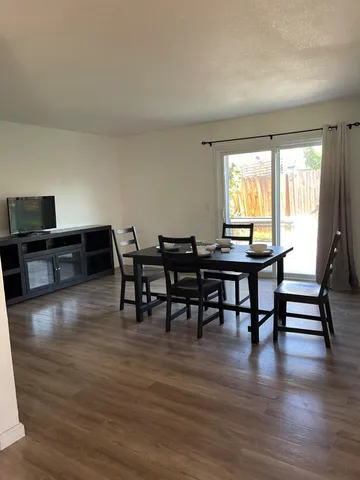 a view of a dining room with furniture and wooden floor