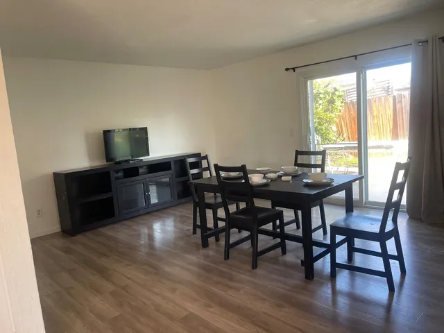 a view of a dining room with furniture window and wooden floor