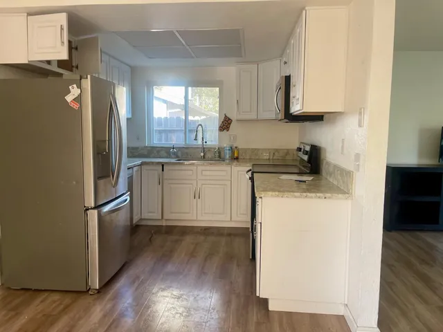 a kitchen with a sink cabinets and stainless steel appliances