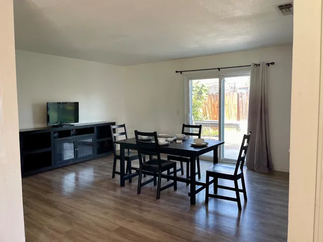 a view of a dining room with furniture and wooden floor