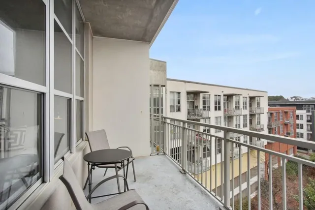 a balcony with table and chairs