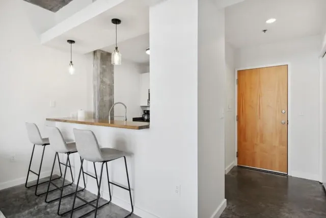 a view of a room with table and chairs