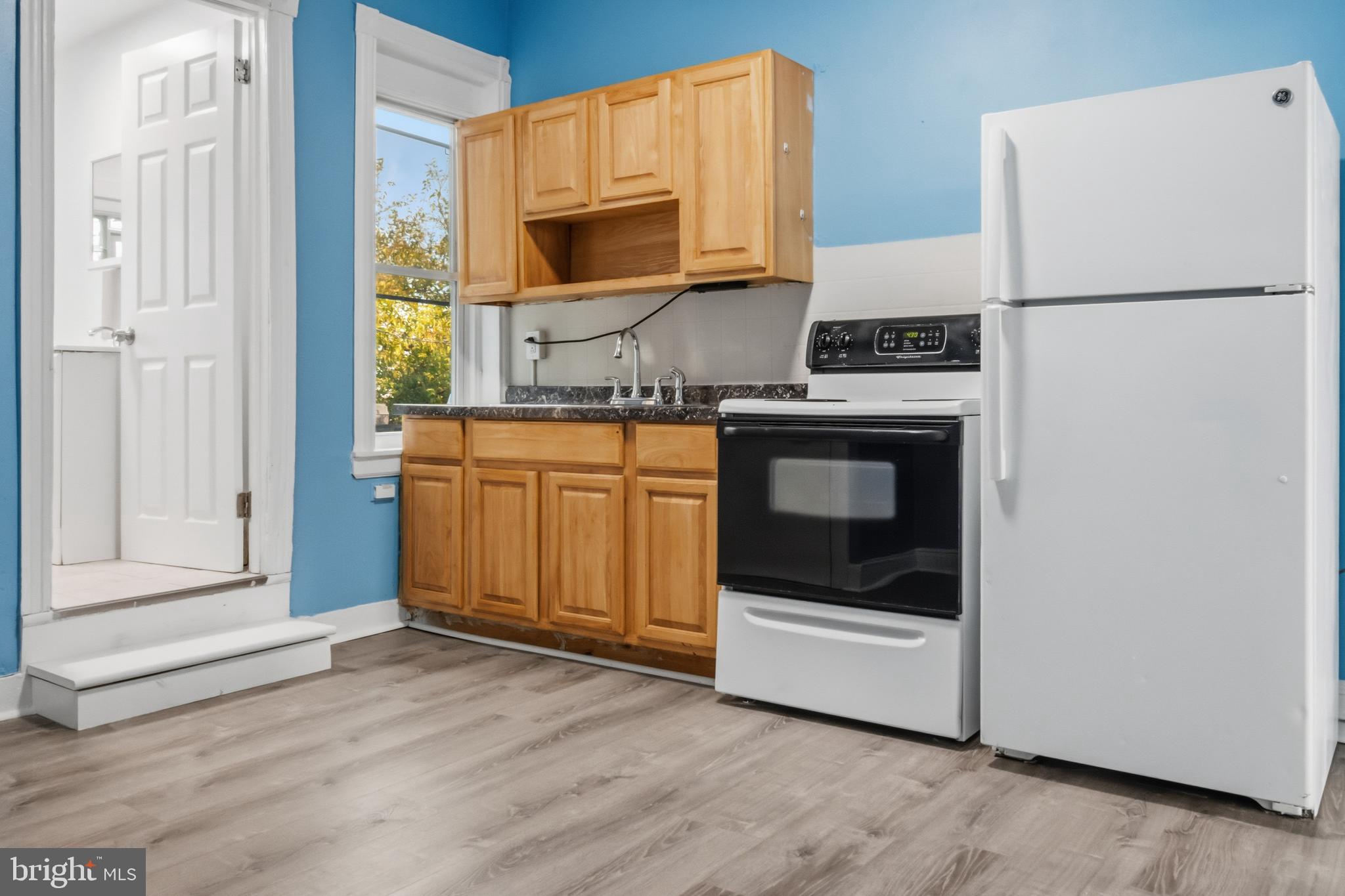3545 North 11th Street, Unit 3 Philadelphia, PA 19140 - Photo 4 of 11 a kitchen with stainless steel appliances a stove a microwave and a refrigerator