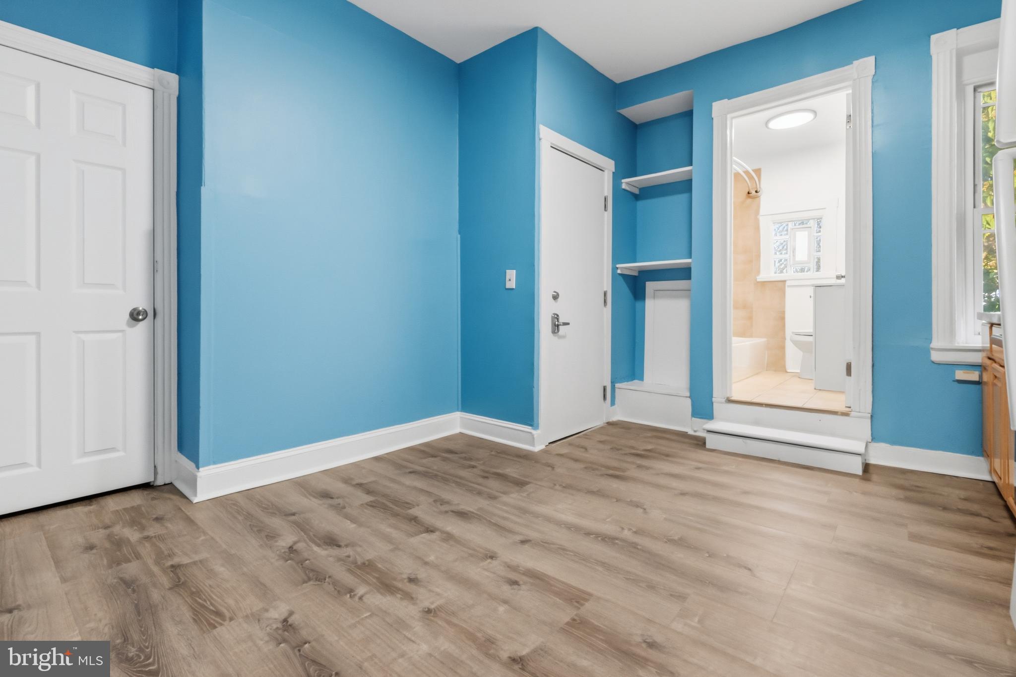 3545 North 11th Street, Unit 3 Philadelphia, PA 19140 - Photo 5 of 11 a view of an empty room with wooden floor and a window