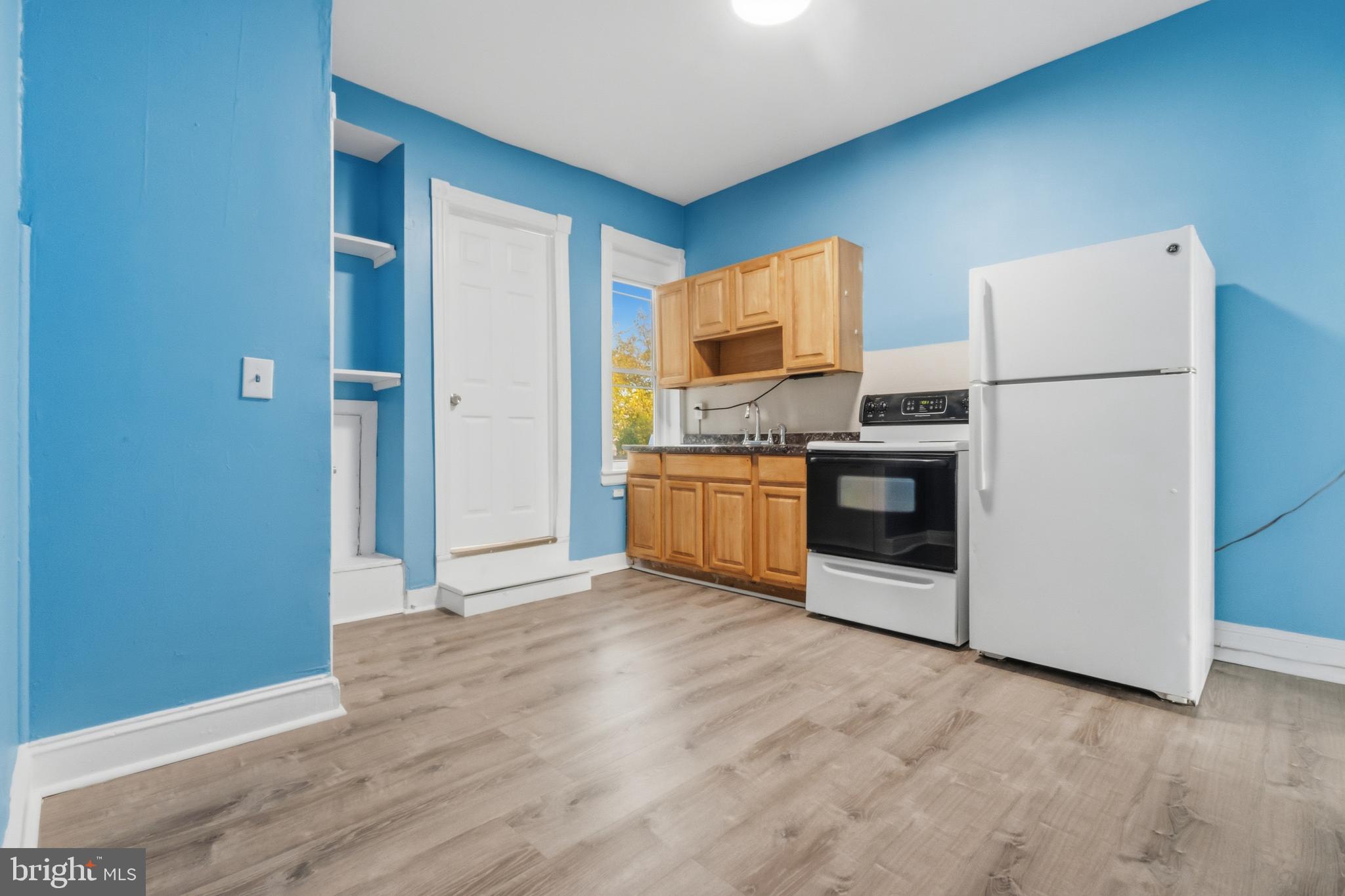 3545 North 11th Street, Unit 3 Philadelphia, PA 19140 - Photo 6 of 11 a view of kitchen with stainless steel appliances granite countertop a stove top oven a sink and a refrigerator