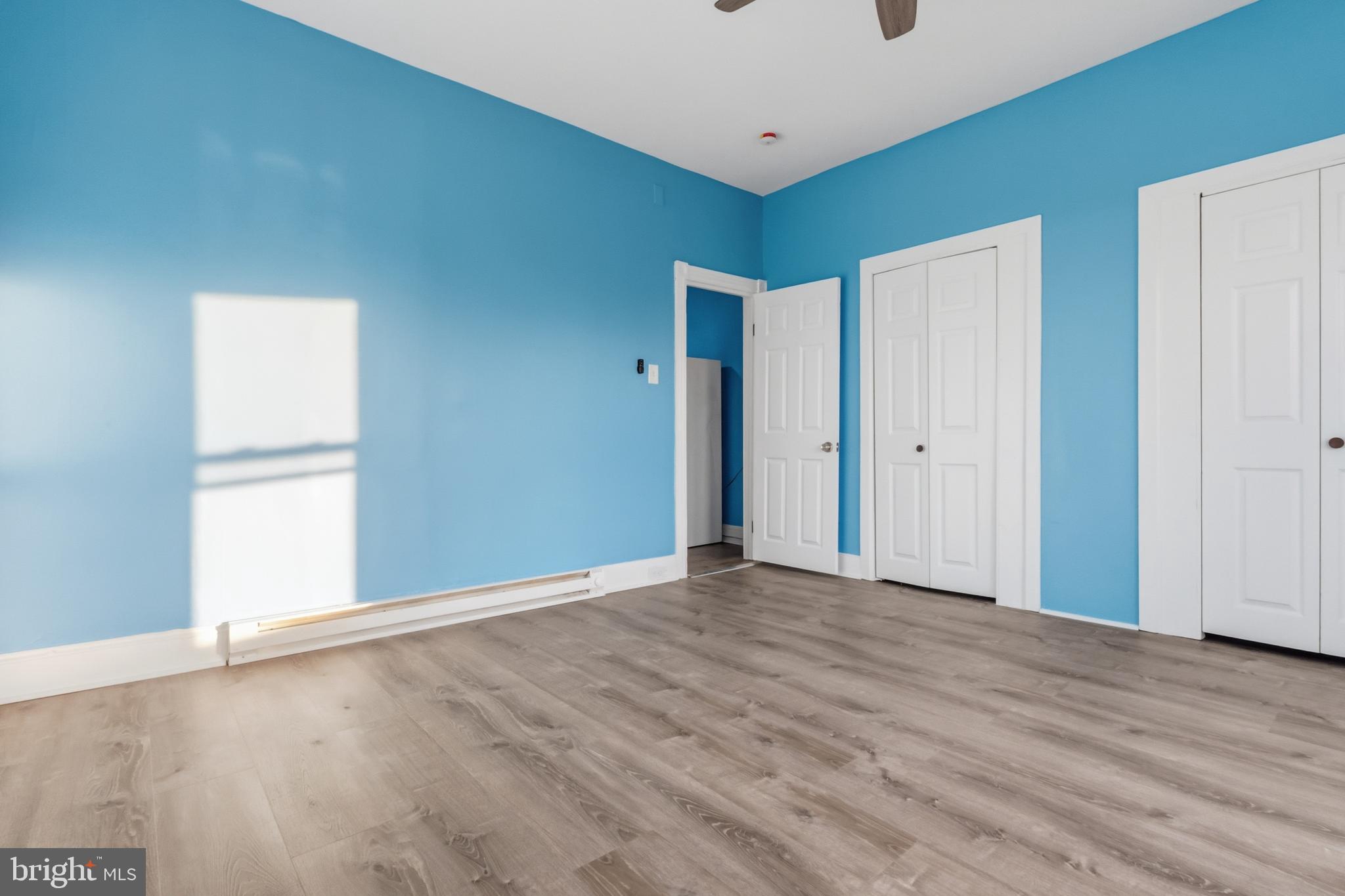 3545 North 11th Street, Unit 3 Philadelphia, PA 19140 - Photo 10 of 11 a view of an empty room with wooden floor and a window