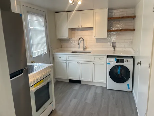 a kitchen with a sink a washer and dryer