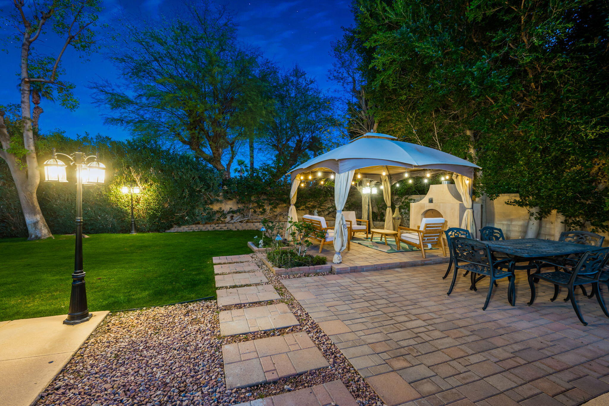 39790 Regency Way Palm Desert, CA 92211 - Photo 14 of 59 a view of a table and chairs under an umbrella