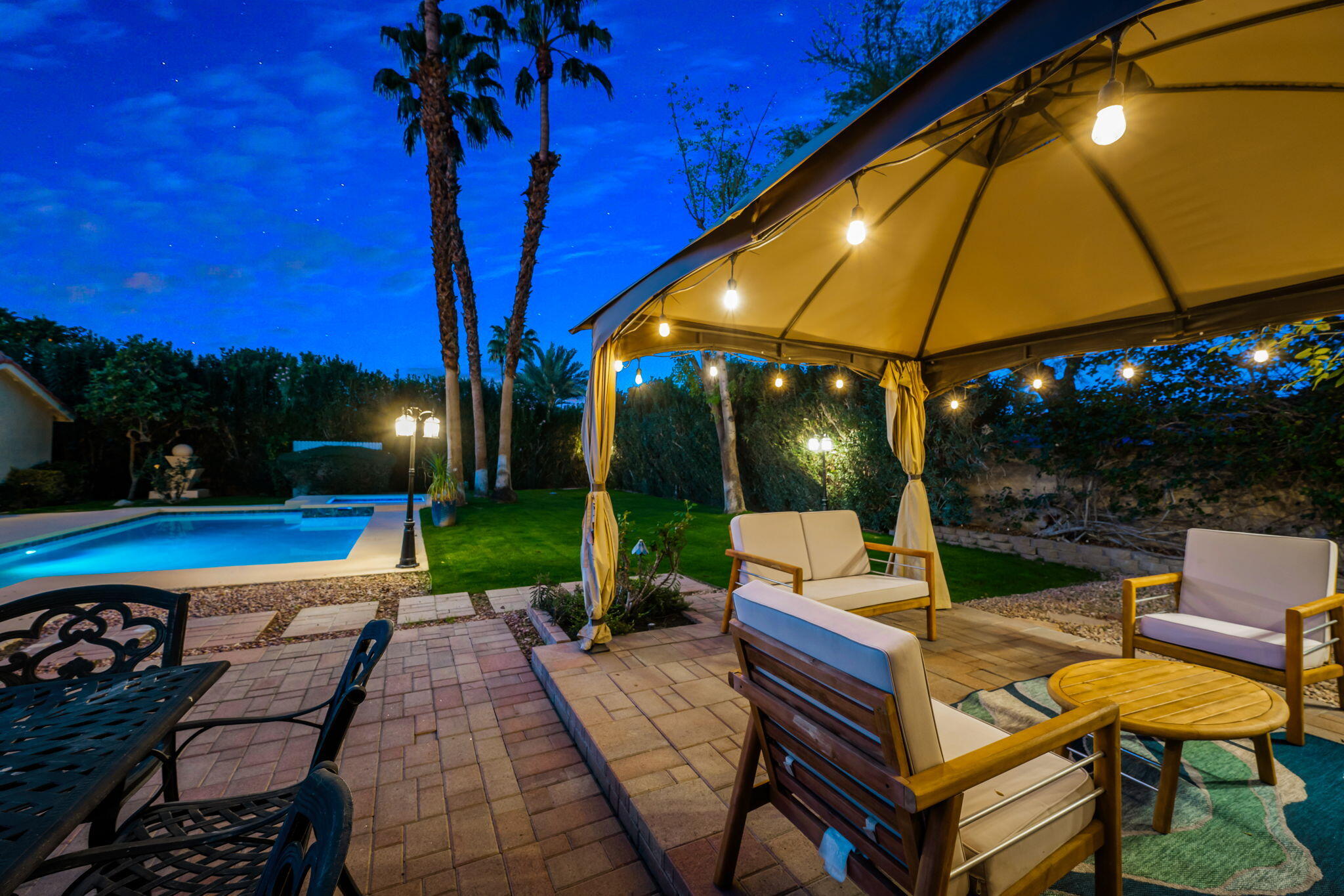 39790 Regency Way Palm Desert, CA 92211 - Photo 2 of 59 a view of a tables and chairs under an umbrella