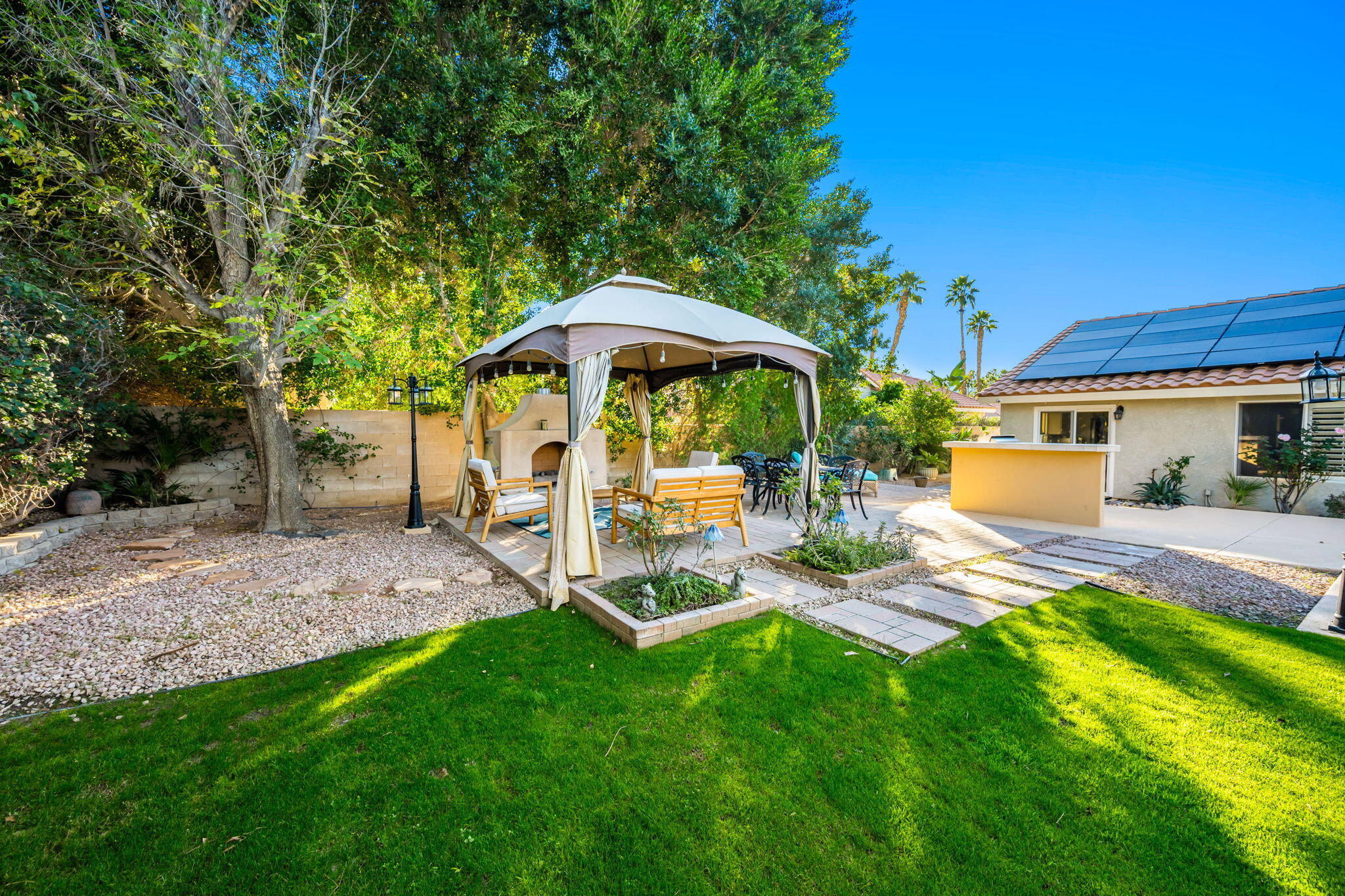 39790 Regency Way Palm Desert, CA 92211 - Photo 32 of 59 a view of a patio with table and chairs under an umbrella