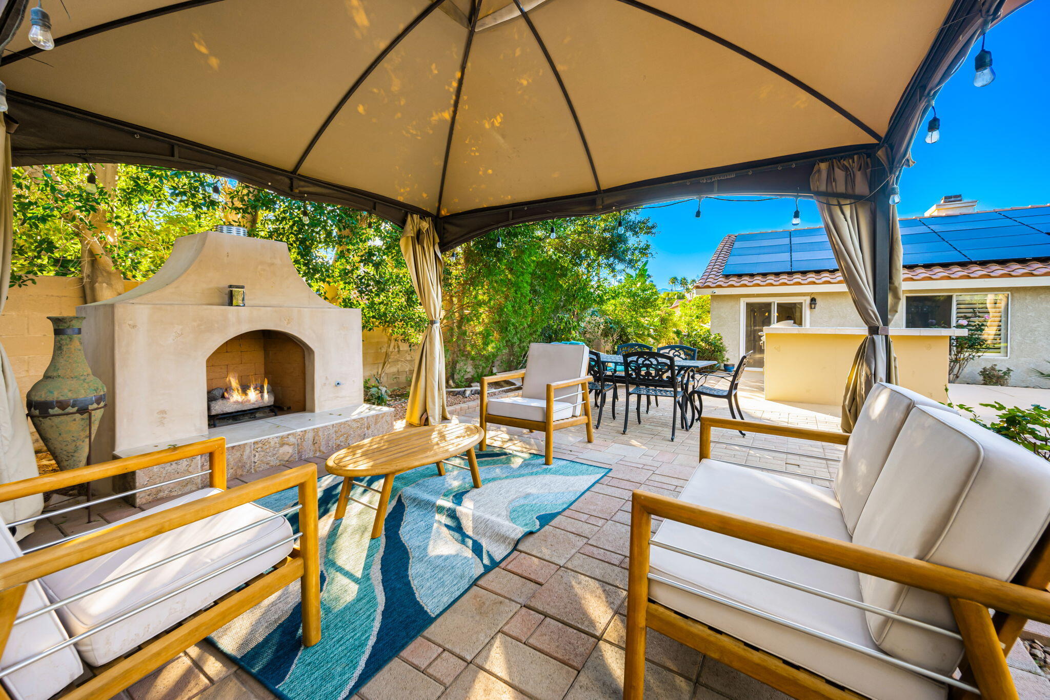39790 Regency Way Palm Desert, CA 92211 - Photo 35 of 59 a view of a patio with a table and chairs under an umbrella