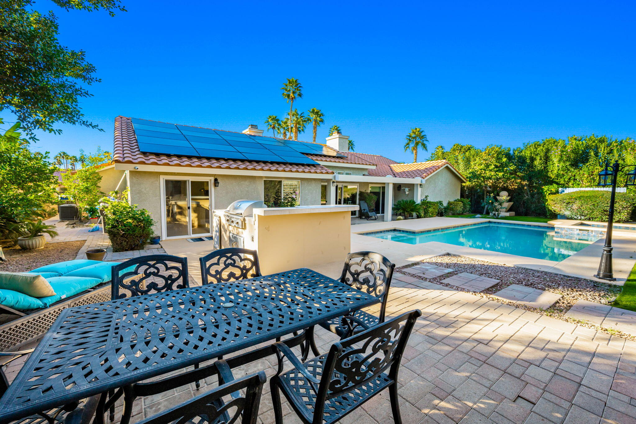 39790 Regency Way Palm Desert, CA 92211 - Photo 37 of 59 a view of a patio with table and chairs and potted plants