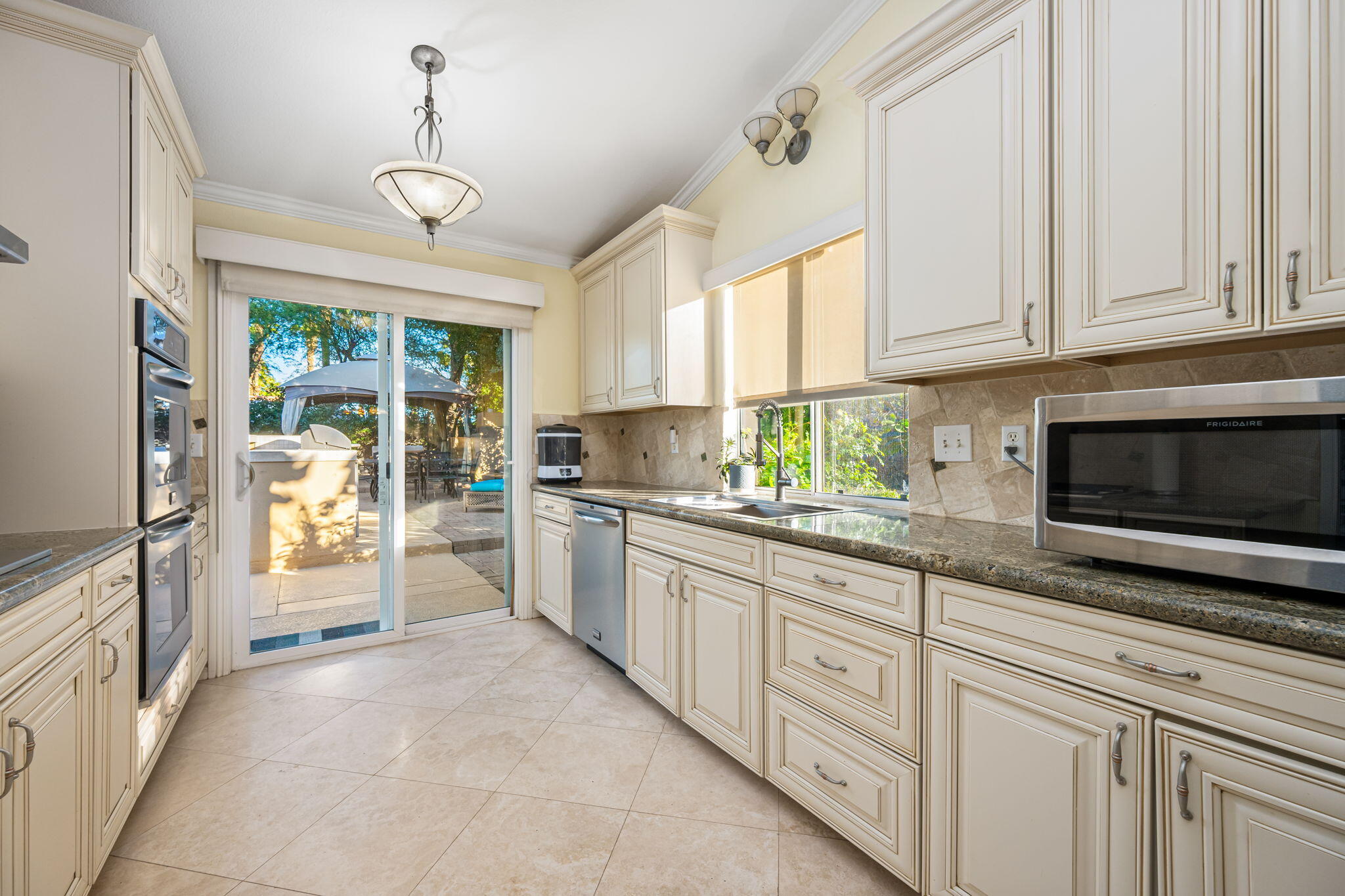 39790 Regency Way Palm Desert, CA 92211 - Photo 43 of 59 a kitchen with granite countertop a stove a sink and a refrigerator