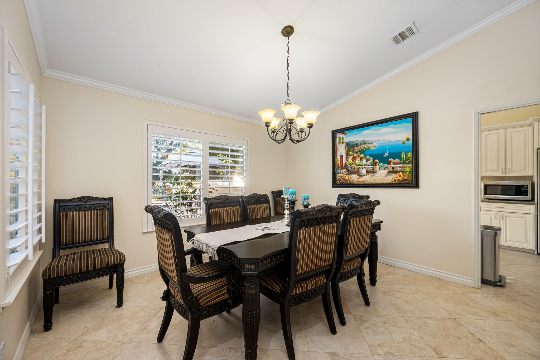 39790 Regency Way Palm Desert, CA 92211 - Photo 47 of 59 a dining room with furniture a chandelier and window
