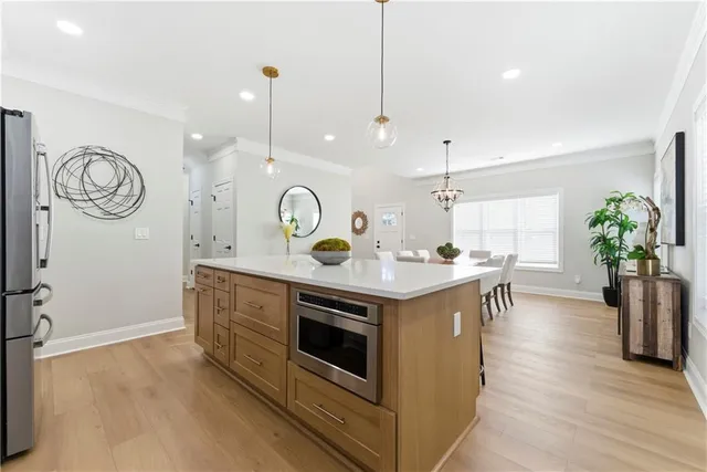 a kitchen with a stove and a wooden floor