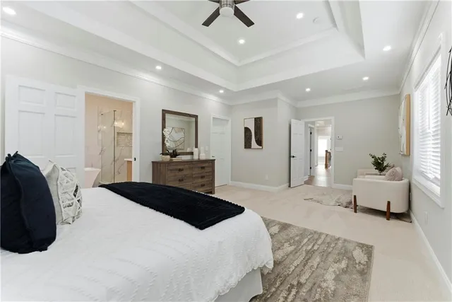 a bedroom with a bed mirror and window