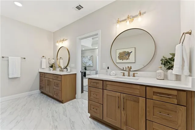 a bathroom with a double vanity sink and a mirror