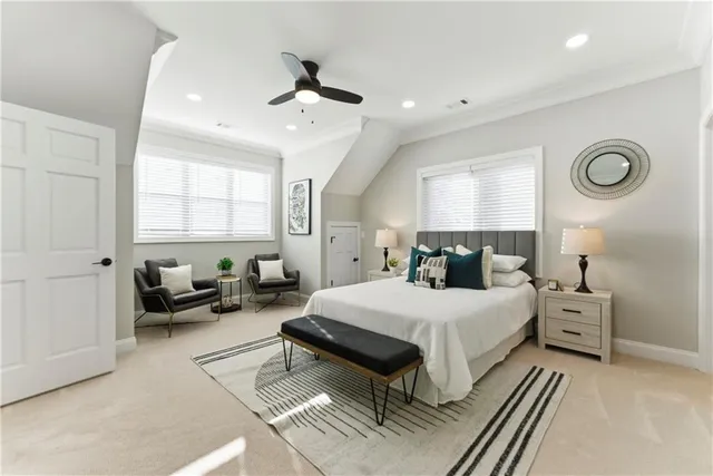 a spacious bedroom with a bed and a chandelier