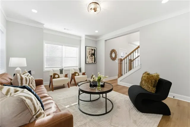 a living room with furniture potted plant and a window