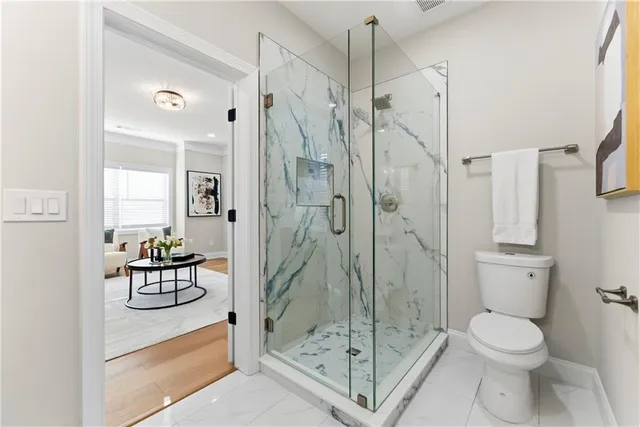 a bathroom with a shower a toilet and a sink