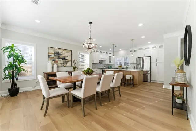 a dining room with furniture and a kitchen view
