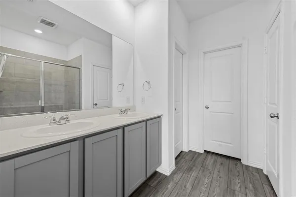 a bathroom with a double vanity sink and mirror