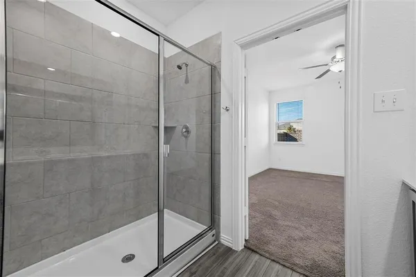 a bathroom with a glass shower door