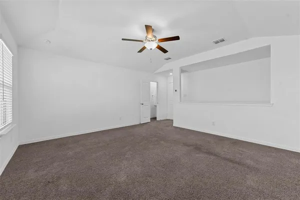 a view of empty room with ceiling fan