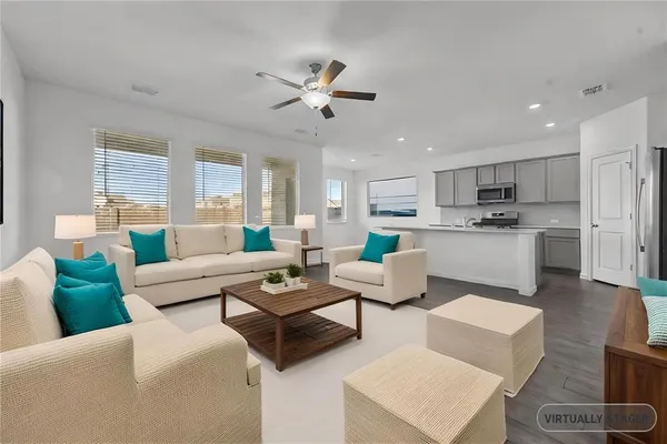 a living room with furniture and kitchen view