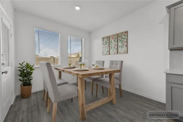 a view of a dining room with furniture window and wooden floor