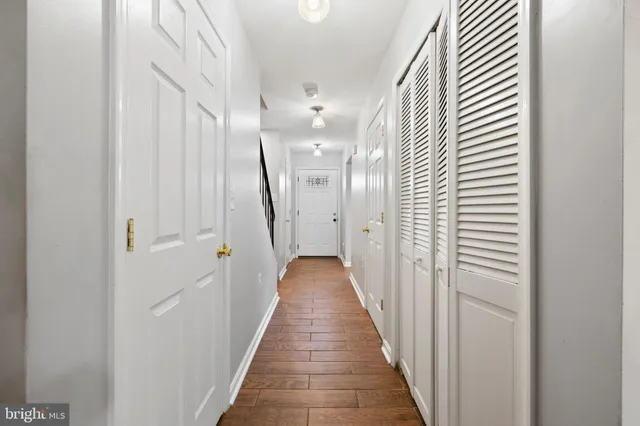 a view of a hallway with wooden floor and staircase