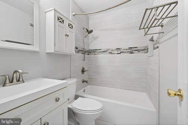 a bathroom with a sink a toilet and a bathtub