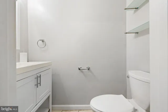 a bathroom with a toilet a sink and vanity