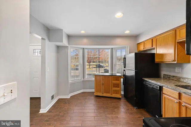 a kitchen with stainless steel appliances granite countertop a refrigerator stove top oven and sink