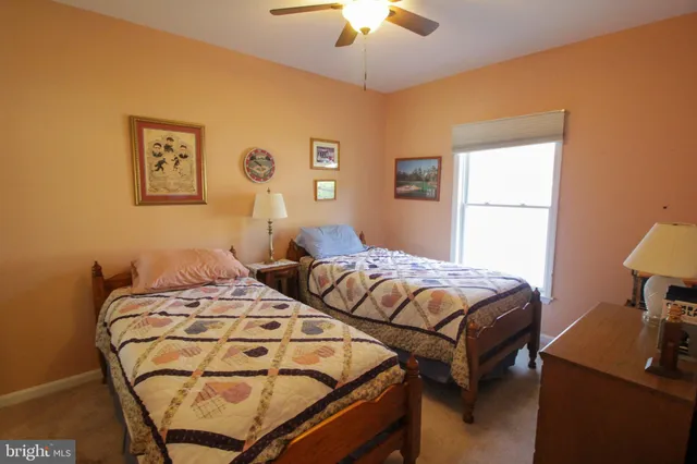 a bedroom with two beds and a chandelier