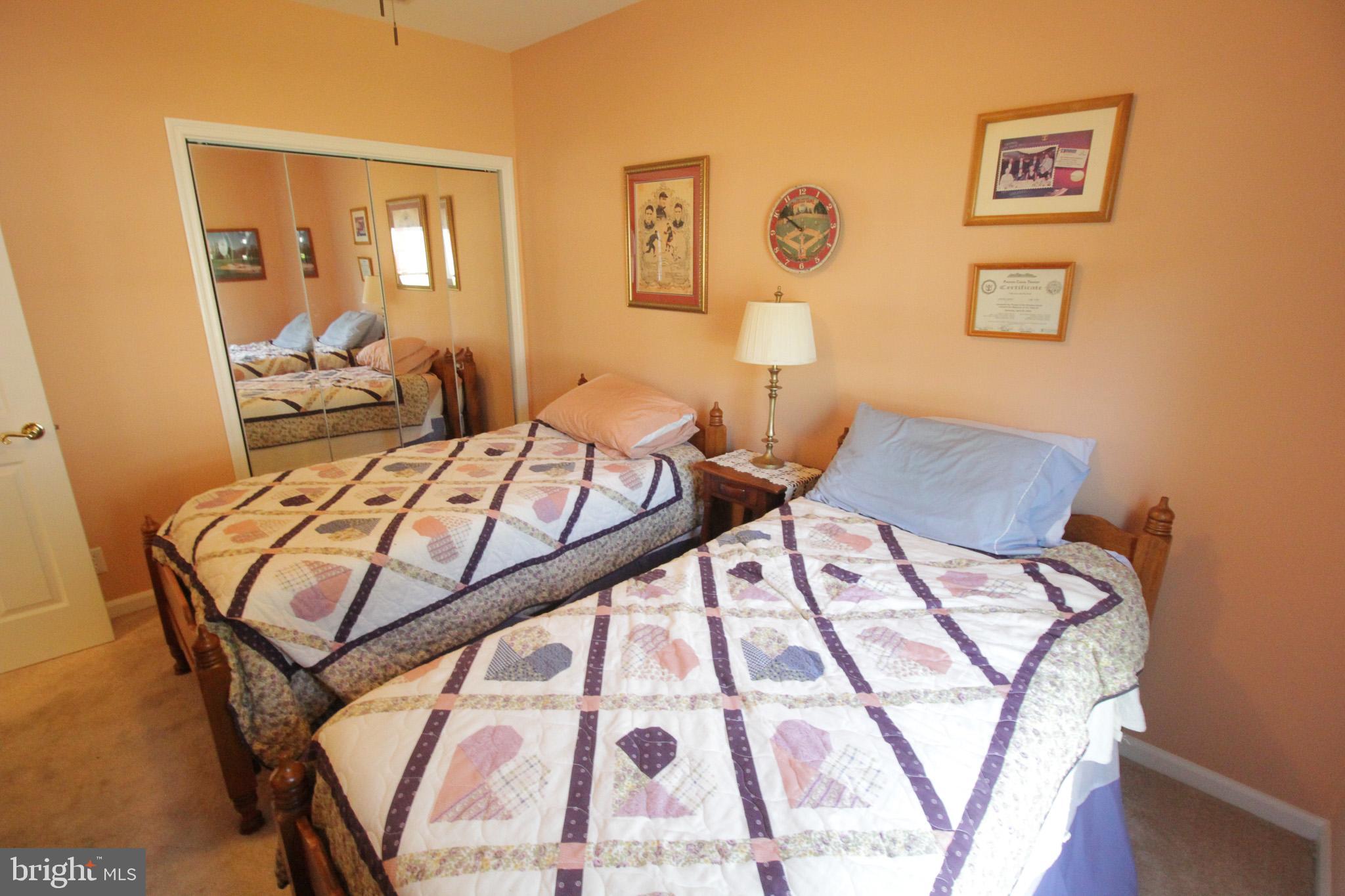 32464 Approach Way, Unit 3278 Millsboro, DE 19966 - Photo 13 of 47 a bedroom with a bed and wooden floor