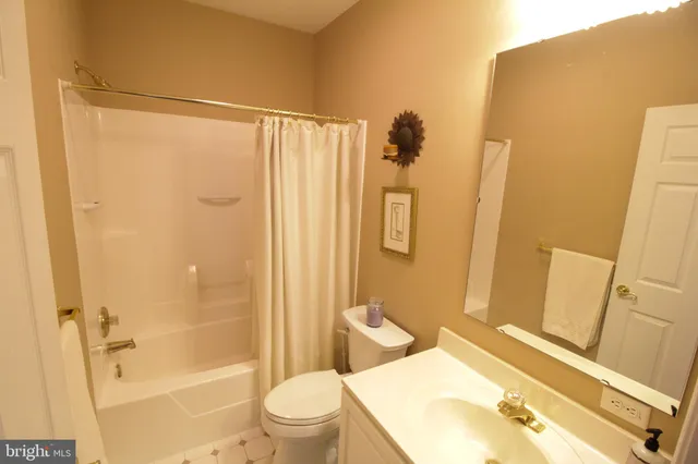 a bathroom with a shower toilet and sink