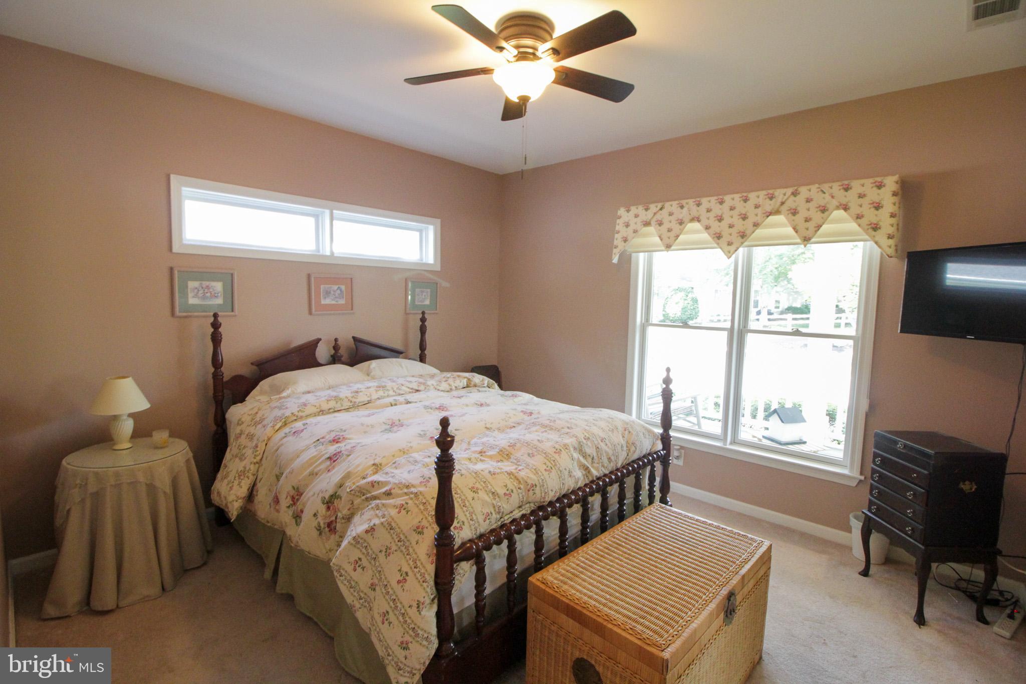 32464 Approach Way, Unit 3278 Millsboro, DE 19966 - Photo 15 of 47 a bedroom with a bed and a chandelier