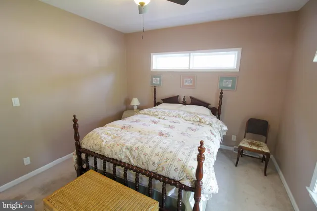 a bedroom with a bed and a dresser in it