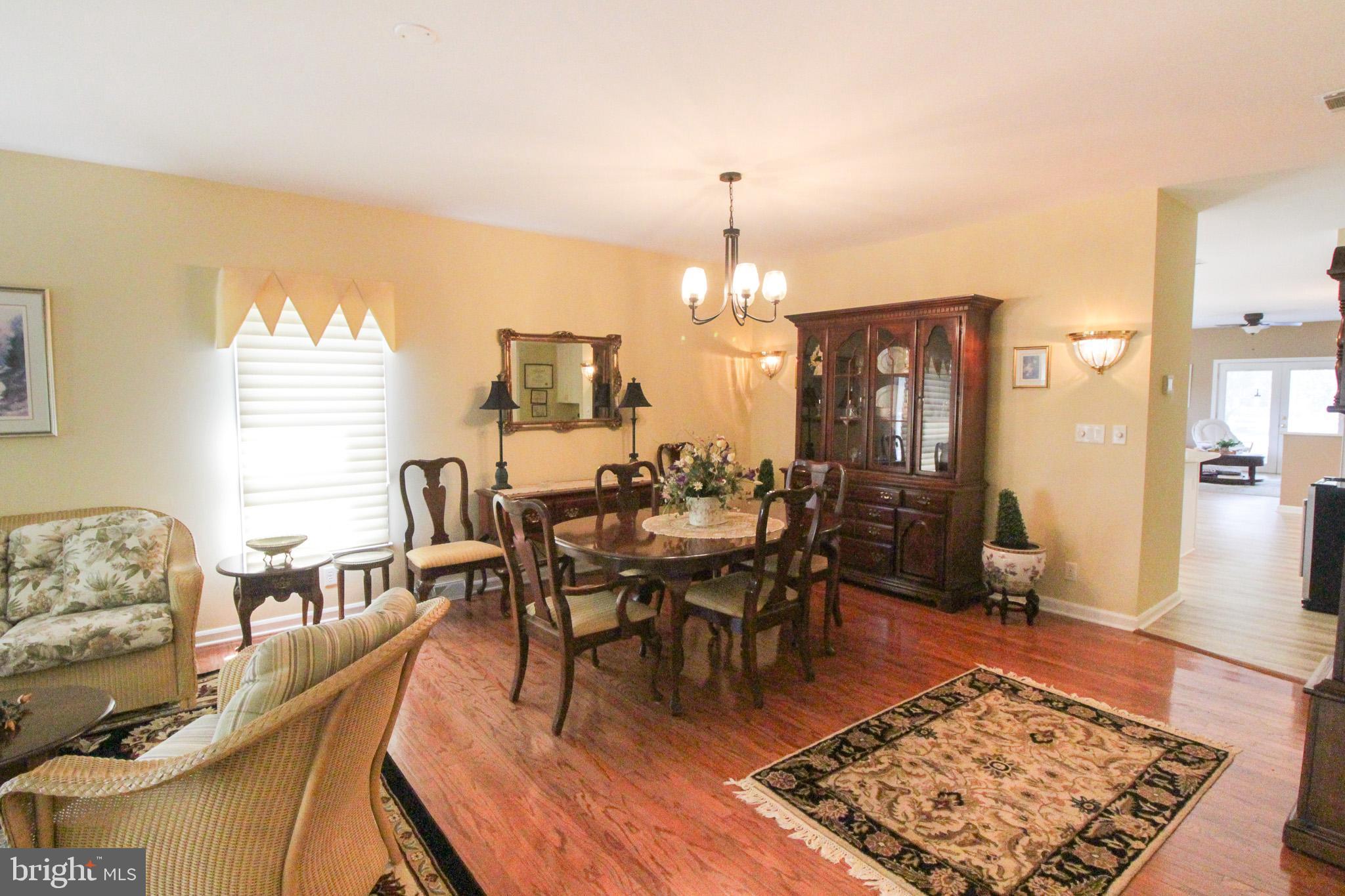 32464 Approach Way, Unit 3278 Millsboro, DE 19966 - Photo 18 of 47 a view of a dining room with furniture