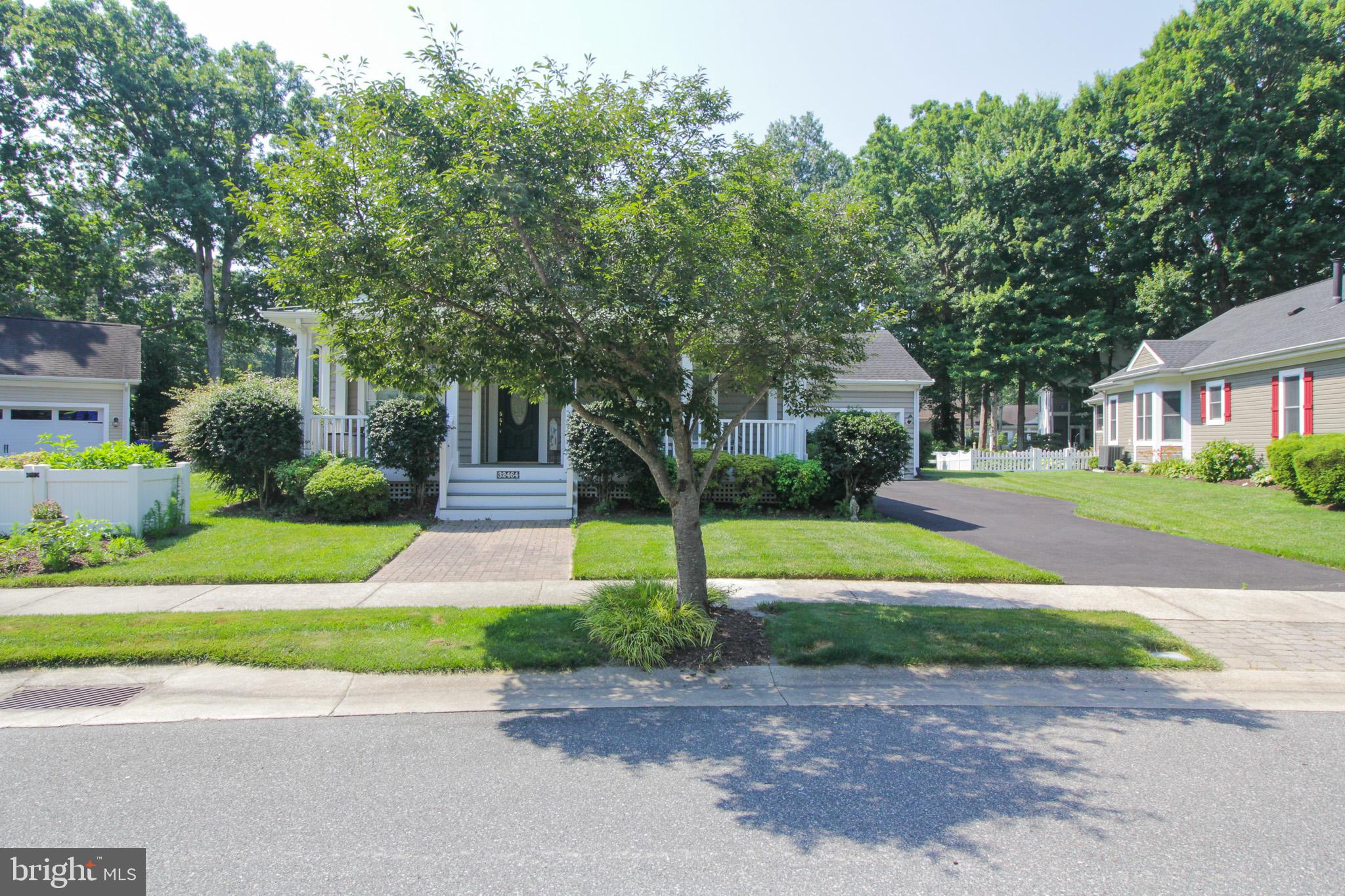 32464 Approach Way, Unit 3278 Millsboro, DE 19966 - Photo 2 of 47 a front view of a house with a yard and potted plants