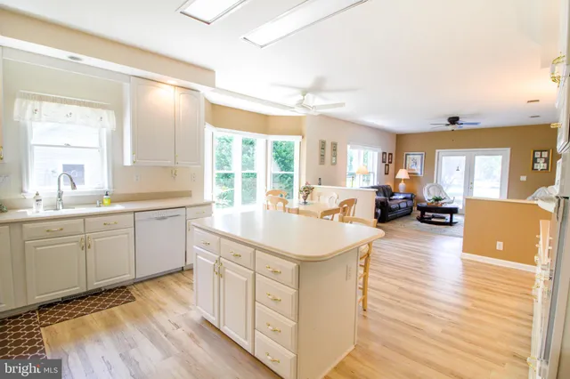 a kitchen with sink cabinets and living room