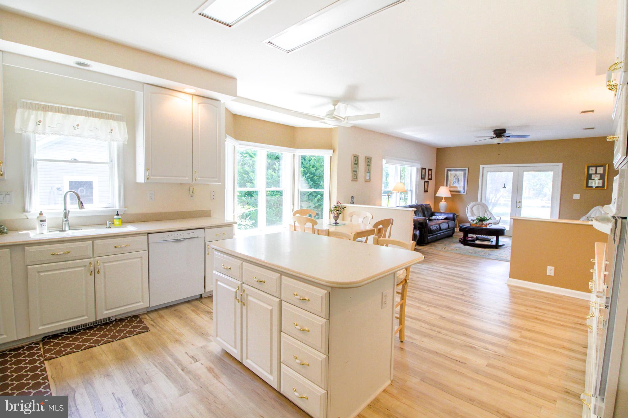 32464 Approach Way, Unit 3278 Millsboro, DE 19966 - Photo 21 of 47 a kitchen with sink cabinets and living room