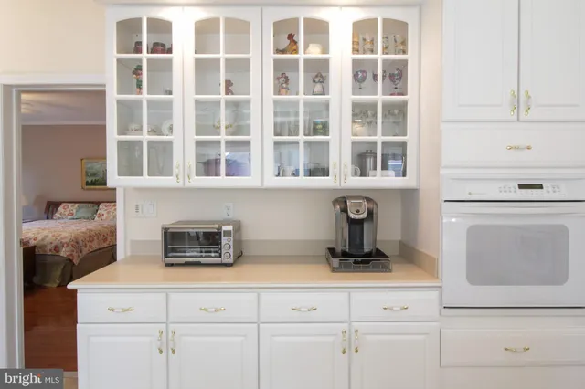a kitchen with a stove and white cabinets