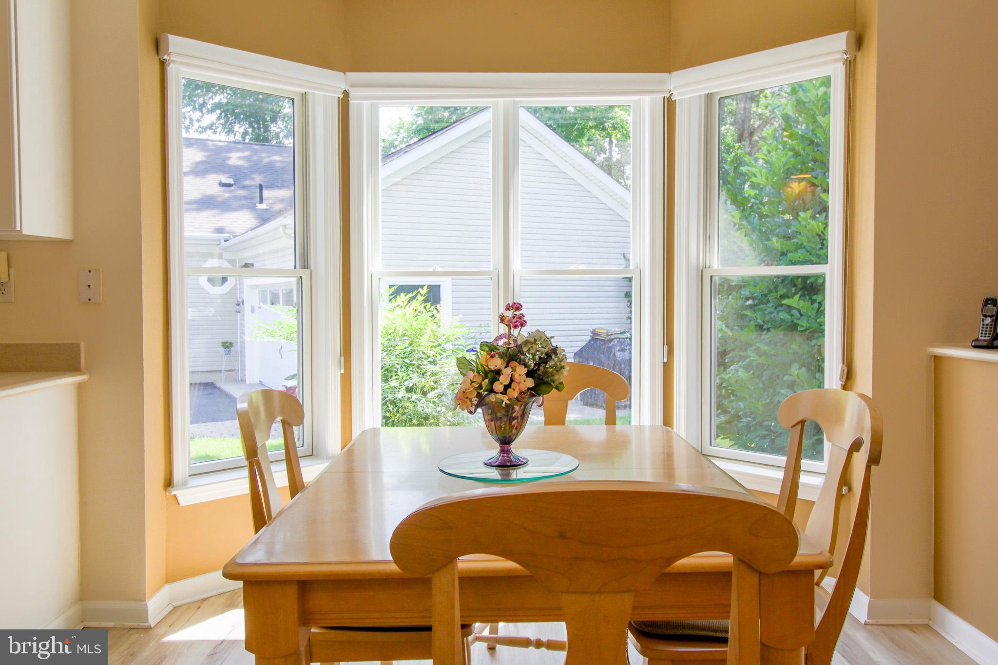 32464 Approach Way, Unit 3278 Millsboro, DE 19966 - Photo 23 of 47 a dining room with furniture window and wooden floor