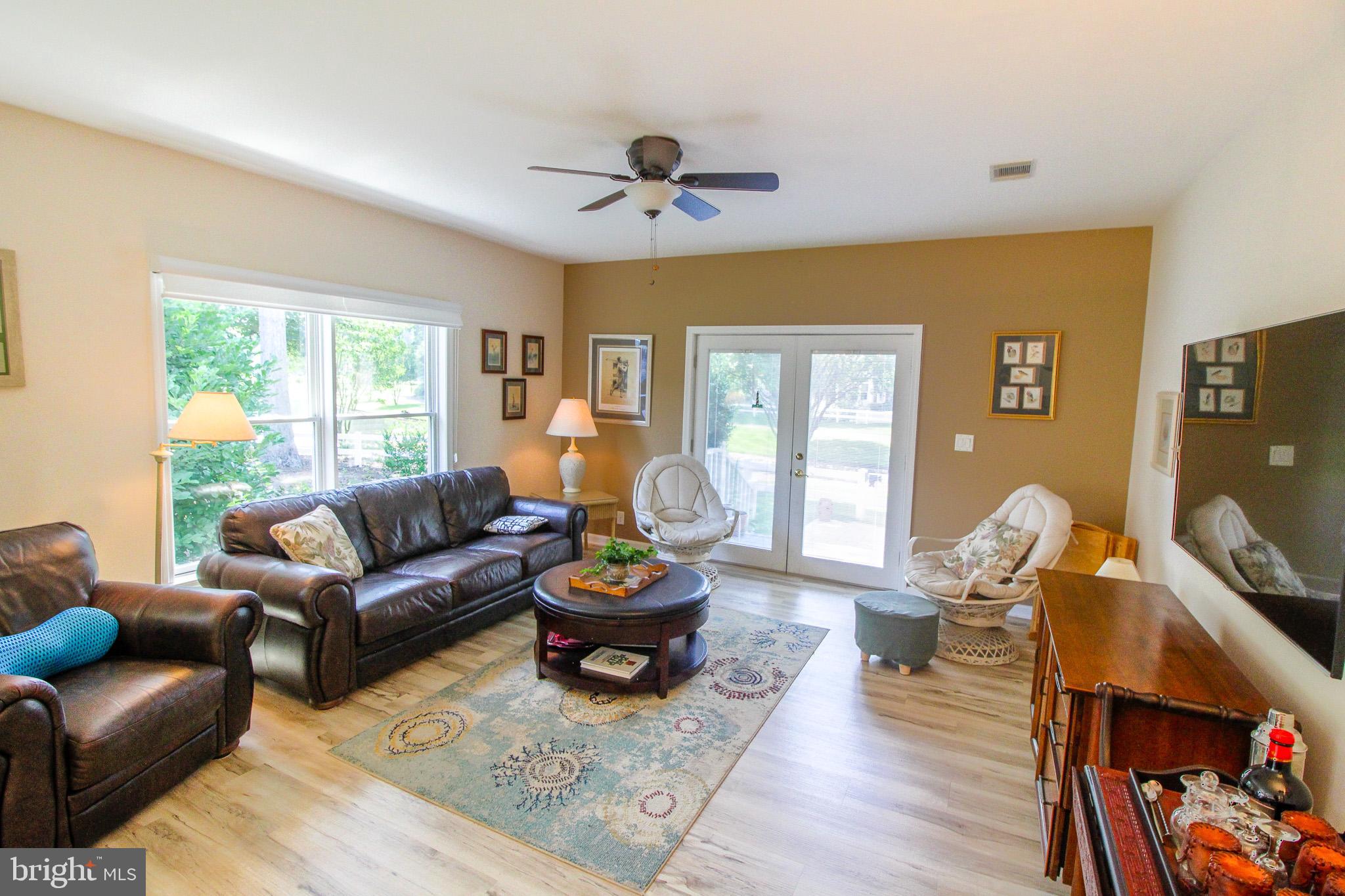 32464 Approach Way, Unit 3278 Millsboro, DE 19966 - Photo 25 of 47 a living room with furniture and a flat screen tv