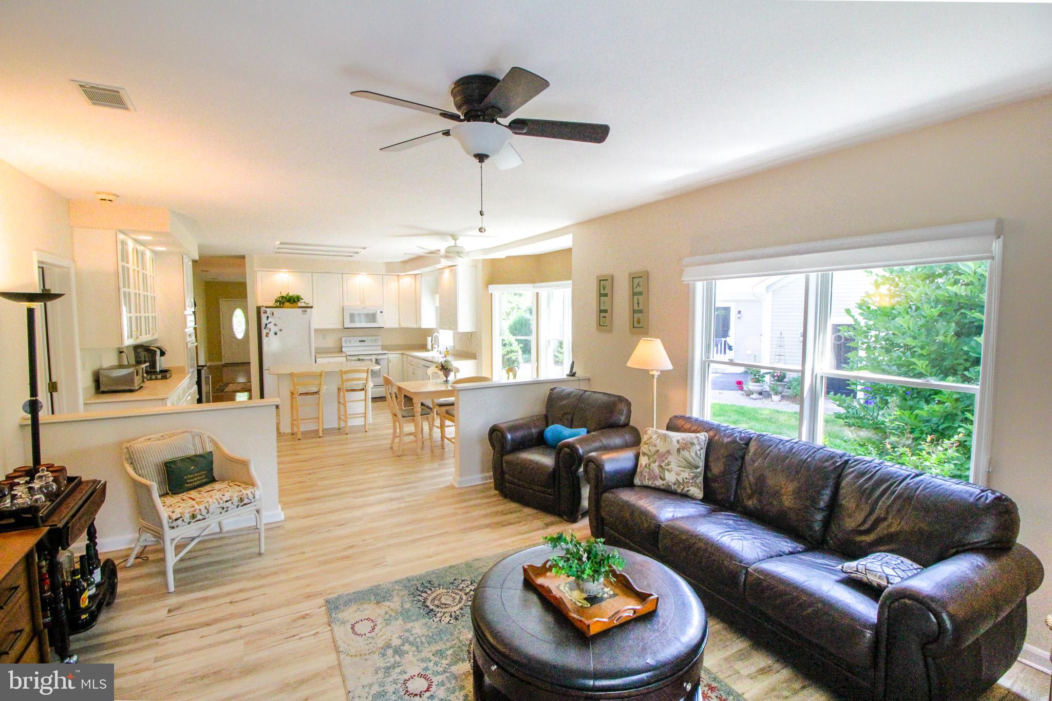 32464 Approach Way, Unit 3278 Millsboro, DE 19966 - Photo 27 of 47 a living room with furniture and a large window