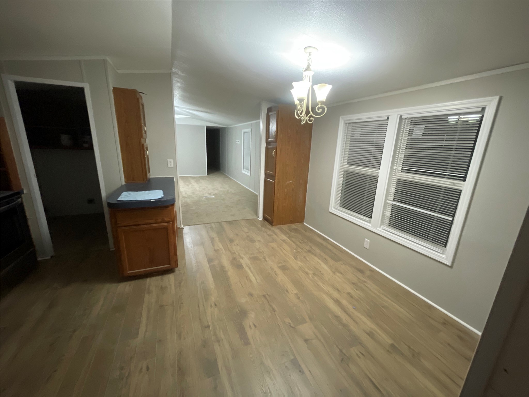 215 Greenfield Road Kyle, TX 78640 - Photo 5 of 8 Functional kitchen and dining area offering durable laminate flooring and practical window treatments.
