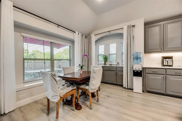 a dining room with furniture and window