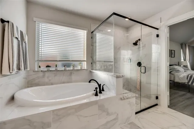 a spacious bathroom with a bathtub and shower